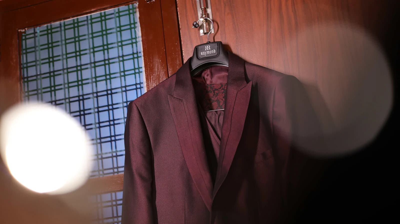 Man in a tailored formal suit and tie, editorial portrait.