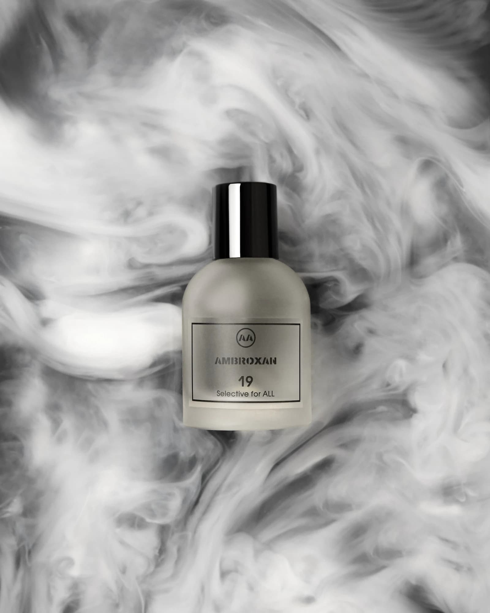 Minimal still life of a clear perfume bottle in soft light.