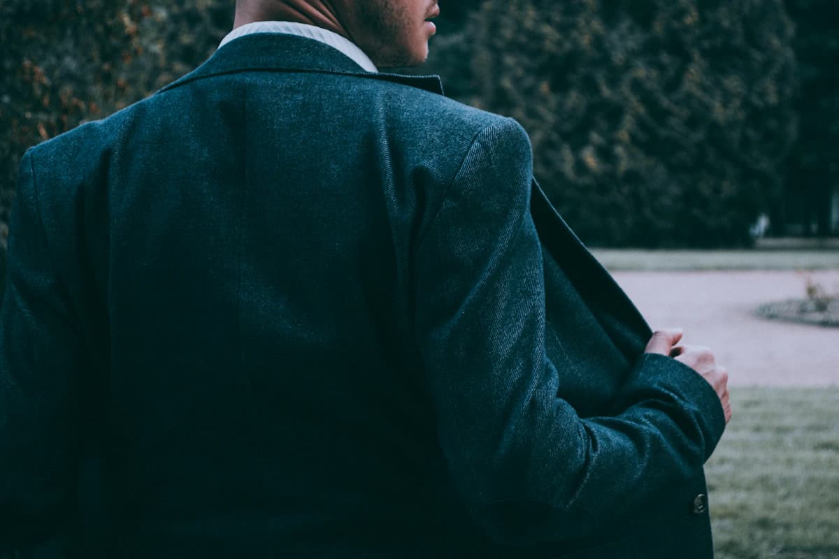 Close-up of a tailored black blazer with structured shoulder.